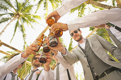 guys holding beverages